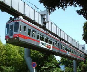 puzzel Hangende monorail. Passagiers van de monorail genieten van het uitzicht op de kermis