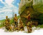 Groep mannen van de Neanderthaler onder de bescherming van een overhangende rots, het realiseren van de individuen verschillende activiteiten: chartting stenen, anderen de voorbereiding van de jacht