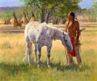 Indiaanse krijger met zijn paard in de buurt van het kamp
