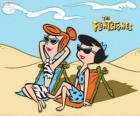 Wilma Flintstone en Betty Rubble zonnebaden op het strand